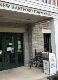 photo of back door of town hall with new white ballot box at the right