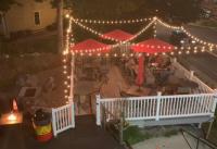 View of patio with tables and lights