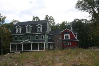 Photo of large house set back with large lawn in front