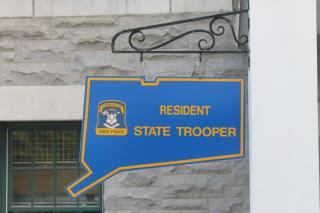 Close-up of sign in shape of state of CT which says "Resident State Trooper"