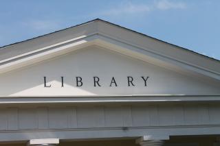 Close-up of triangular peak of front of library building showing word "Library"